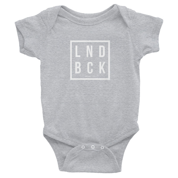 Just Out Here Tryna Get Our LND BCK Infant Bodysuit