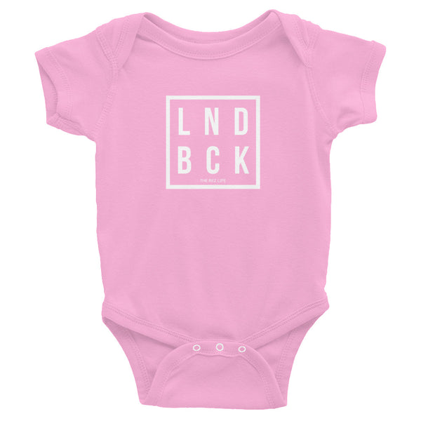 Just Out Here Tryna Get Our LND BCK Infant Bodysuit