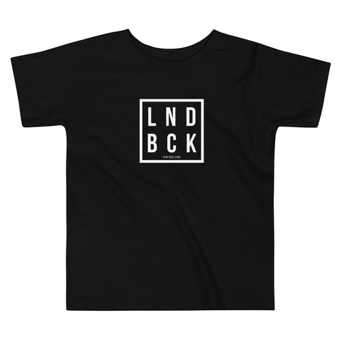 Just Out Here Tryna Get Our LND BCK Toddler Tee